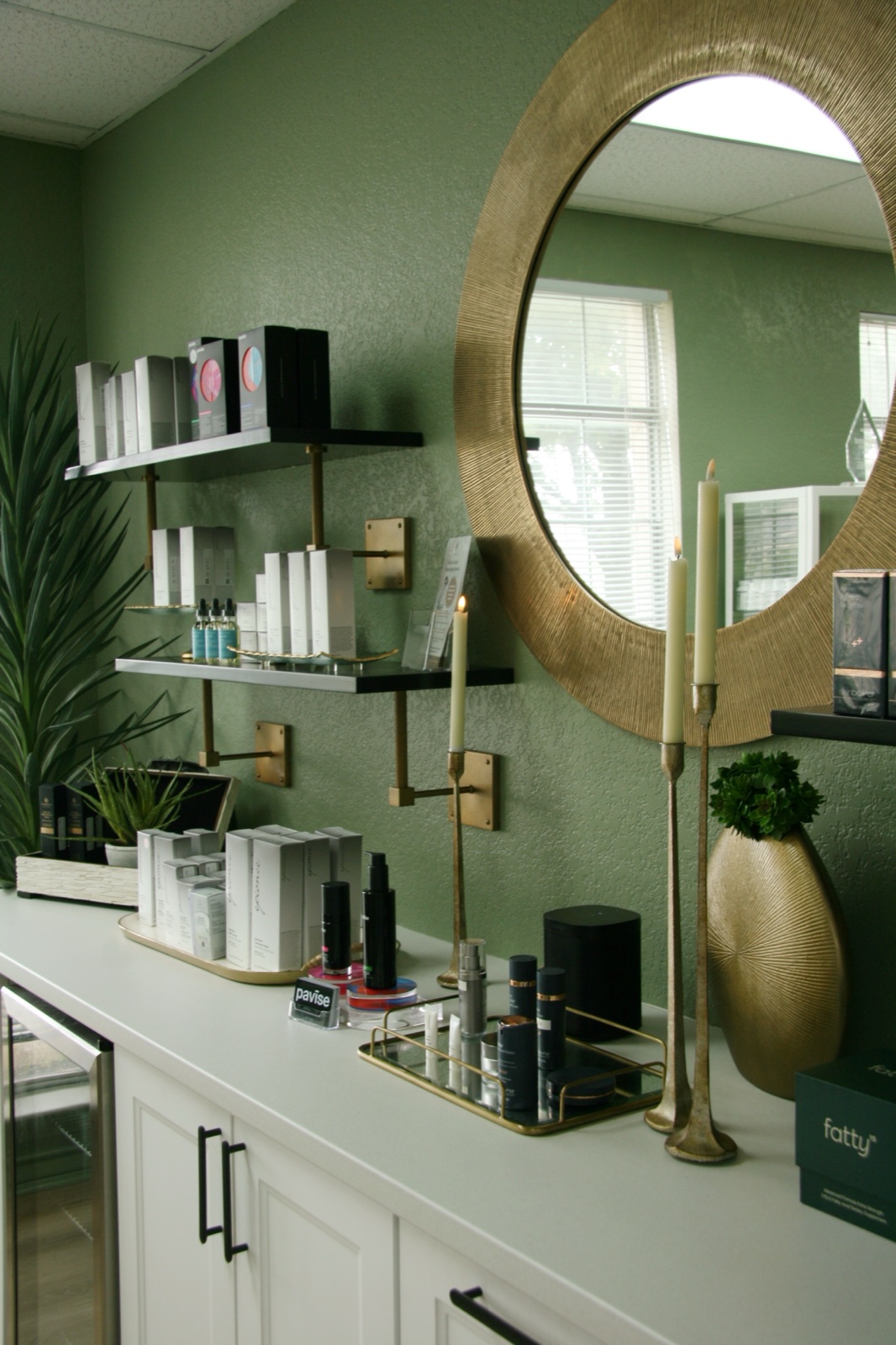 The Bespoke product wall and round mirror — wellness room context